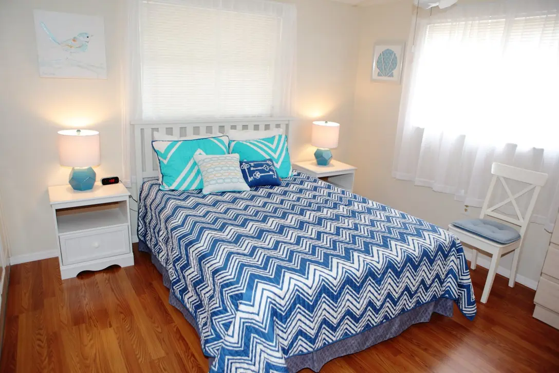 Queen bedroom with blue chevron bedding and wood floor, Happy Turtle B