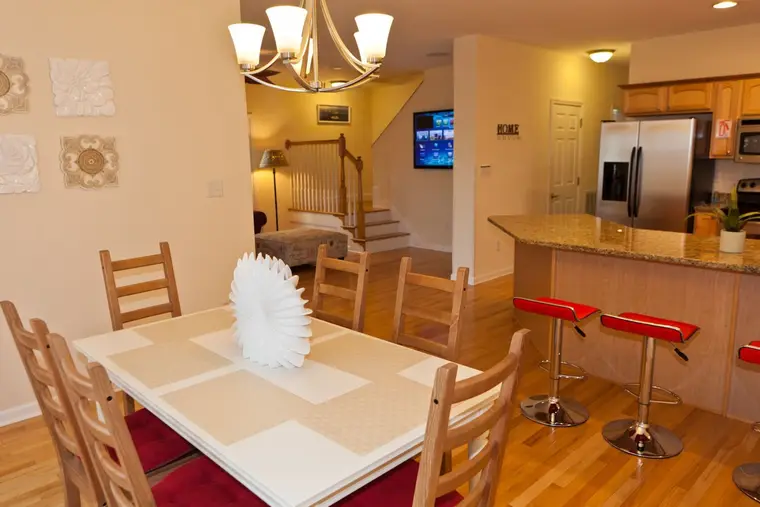 Dining area beside the kitchen with chandelier, Happy Island Cottage