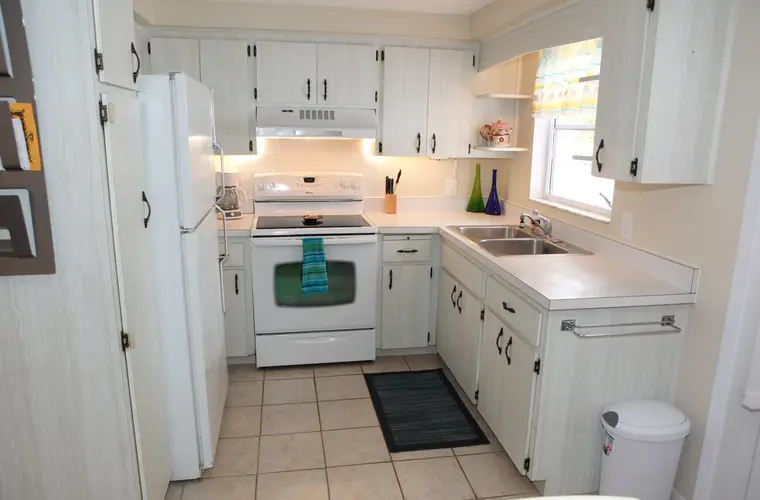 Full kitchen with electric range, full-size refrigerator, and window over the sink, Happy Turtle B