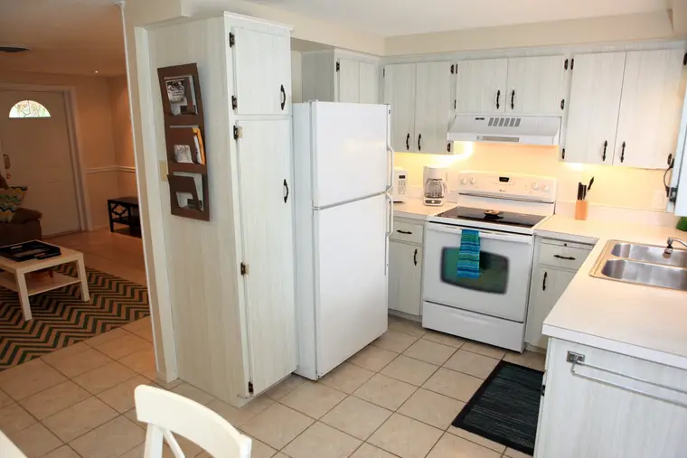 Kitchen with white cabinets and full-size appliances, Happy Turtle B